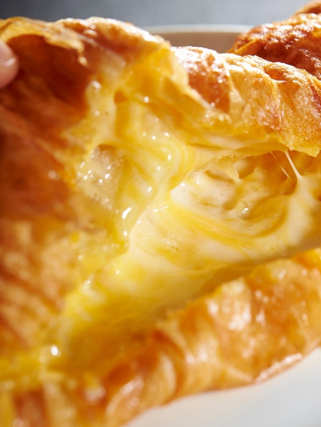 Cheesy croissant with flaky layers.