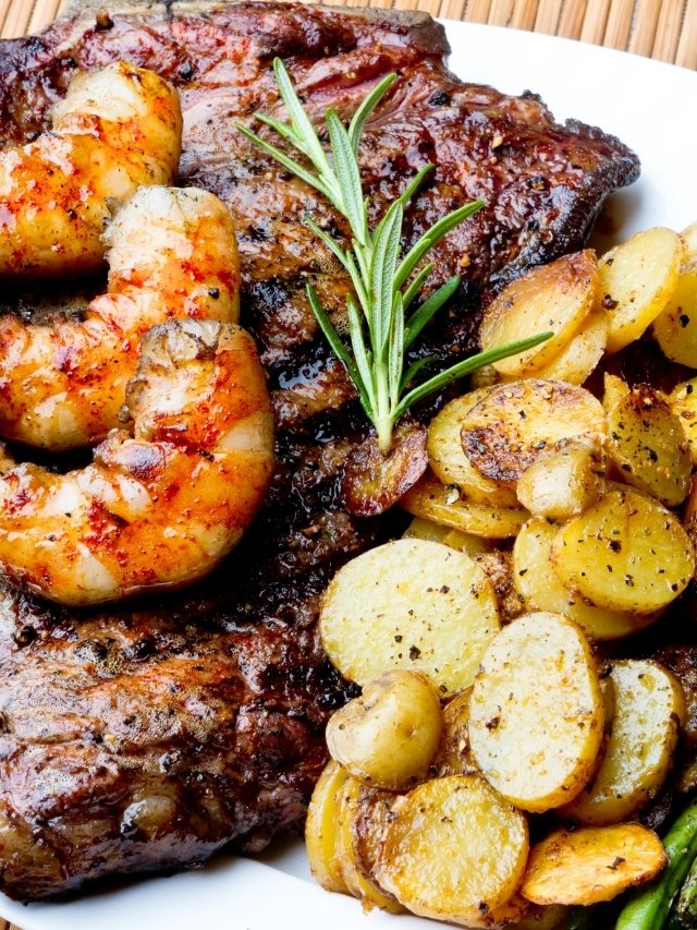 Steak, shrimp, and roasted potatoes dish
