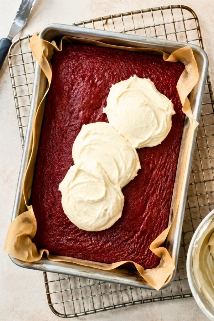 Red Velvet Brownies in a baking pan with cream cheese frosting