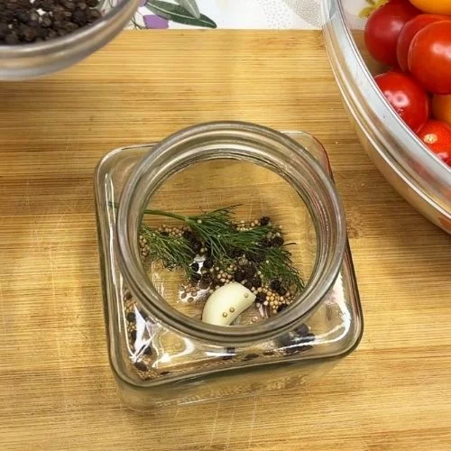 Glass jar with spices and garlic