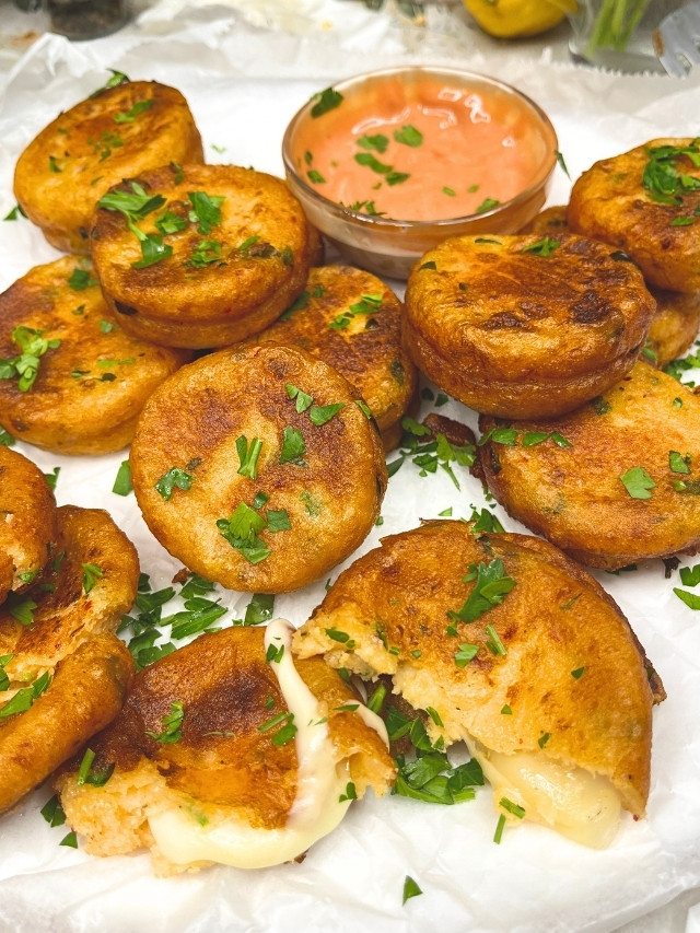 Golden potato pancakes with green garnish and sauce