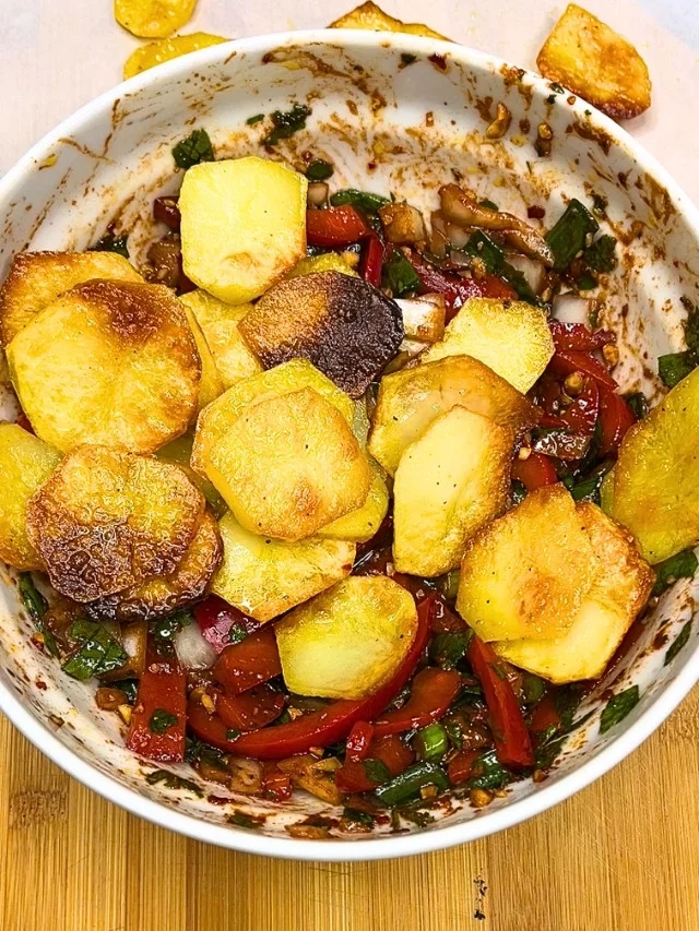 Crispy Roasted Potato Salad with bell pepper and herbs in a bowl