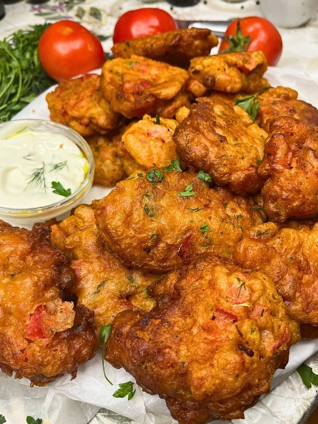 Crispy Greek Tomato Fritters with tzatziki sauce on a plate