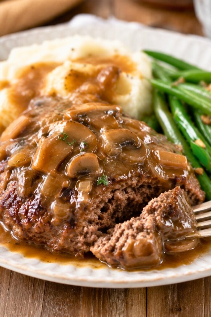 Salisbury Steak with Mushroom Gravy plated with mashed potatoes